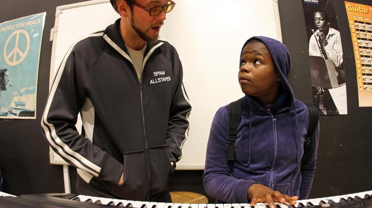 Guitars Over Guns founder Chad Bernstein, left, with North Miami Middle School student Esther Lexine in 2012; Bernstein’s plan to turn guns into musical instruments is a finalist for a Knight Arts Challenge grant.