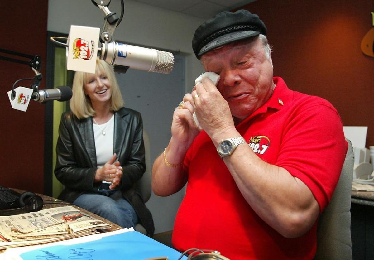 Majik 102.7's morning show host, Rick Shaw wiped a tear from his eye as co-host Donna Davis (left) applauded moments after he announced his retirement from co-hosting the morning show in Nov. 2006. Shaw was on the air in South Florida for more than 50 years.