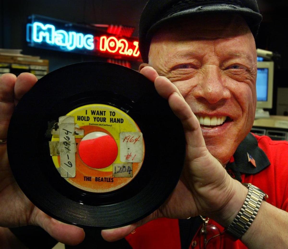 Rick Shaw holds up the original 45 of the Beatles’ hit ‘I Want to Hold Your Hand’ in 2004.