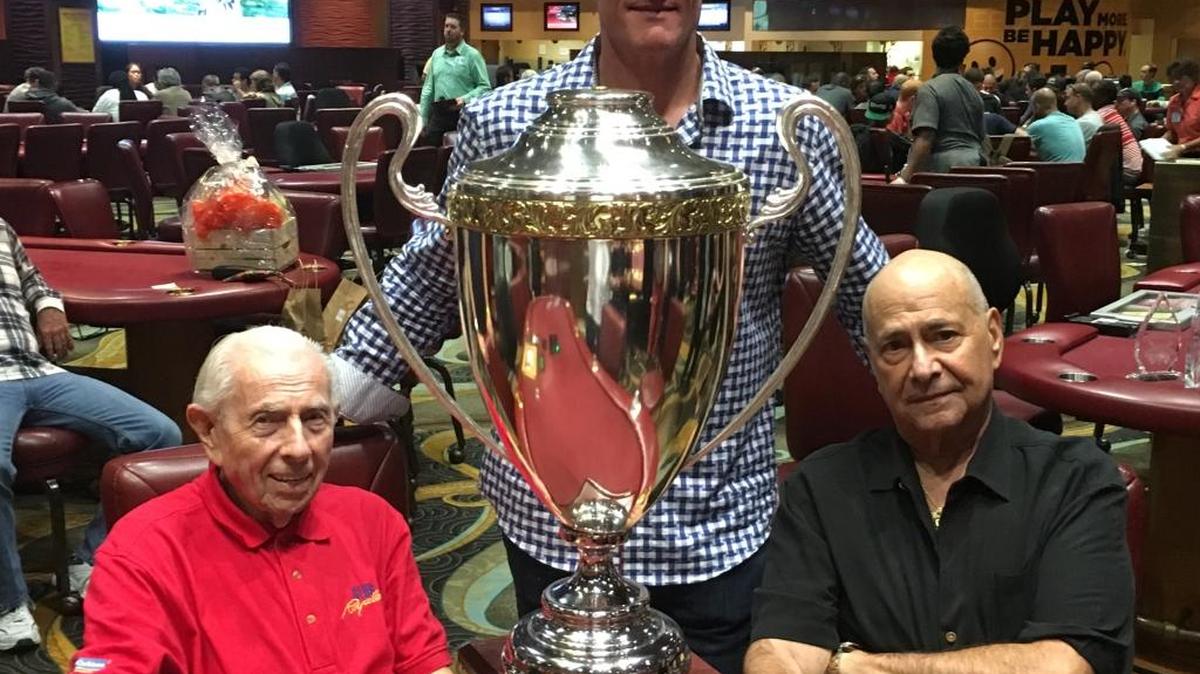 Victor Arnold, left, of Boca Raton, split first prize with Marshall Weinberg of Davie in a tournament to raise money for parents’ quarters at a children’s hospital supported by former Marlins star Jeff Conine, center.