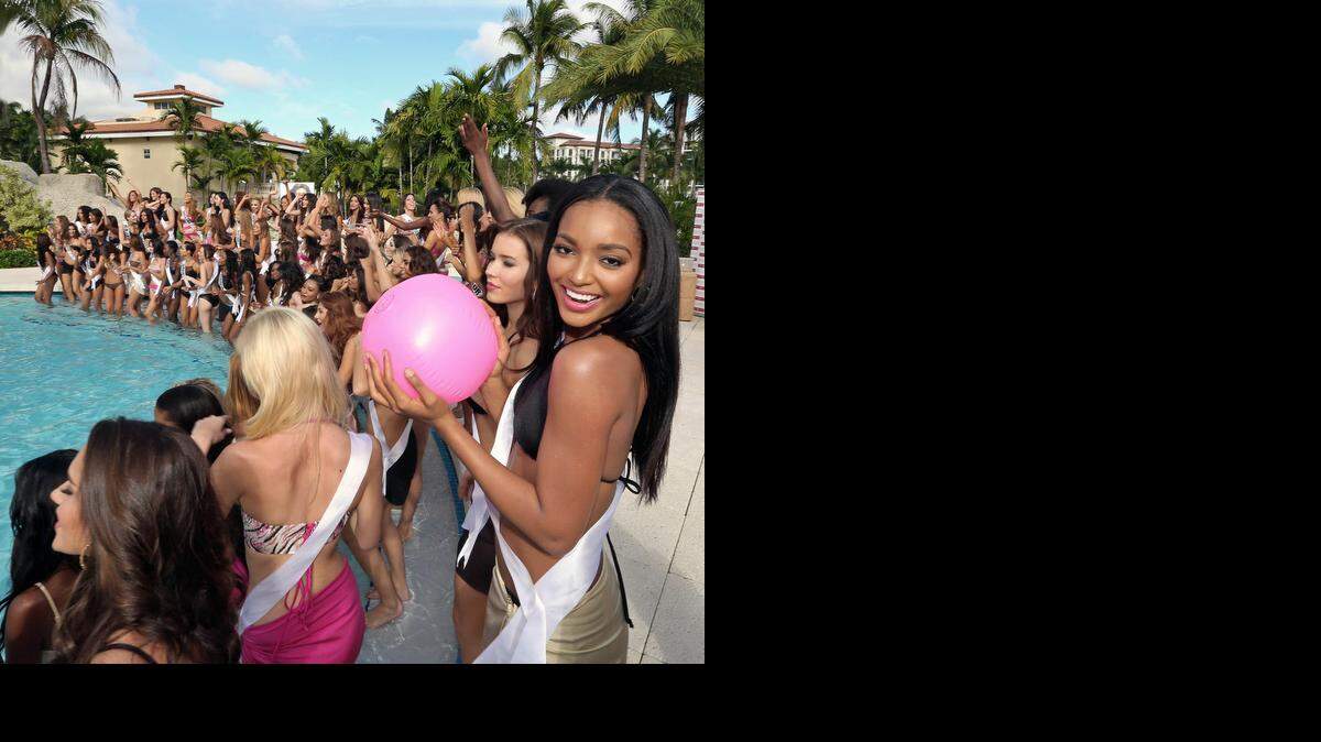 
Miss Guyana Niketa Barker-Miss Guyana smiles with beach ball in hand as she and other Miss Universe contestants hang out poolside modeling swimsuits at Trump National Doral Miami on Wednesday, Jan. 14, 2015.
