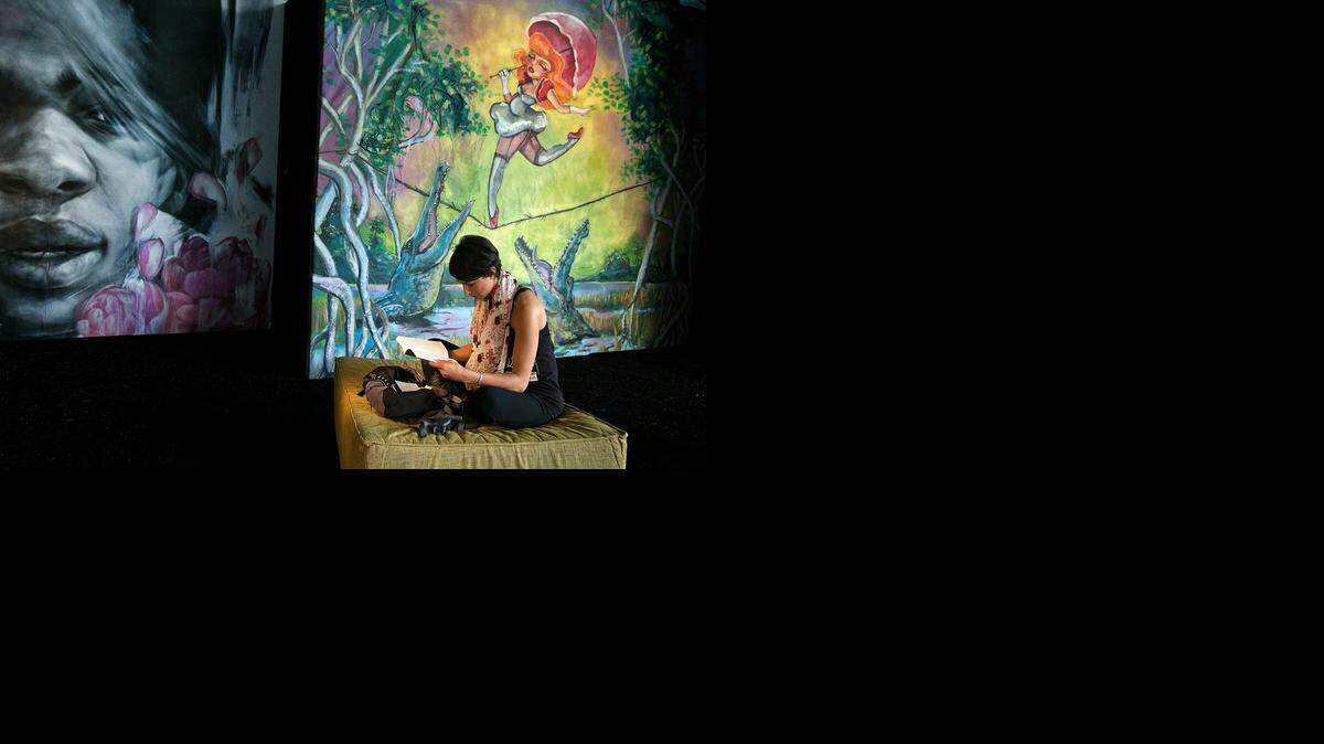 
Brenna Mello of Miami Beach does a little reading in between events inside The Swamp as the Miami Book Fair International opens Sunday, Nov.16, 2014 at Miami Dade College.
