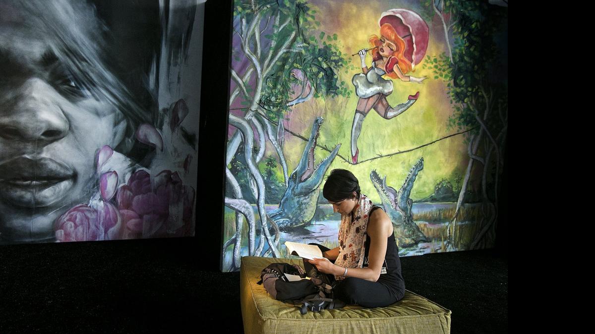 
Brenna Mello of Miami Beach does a little reading in between events inside The Swamp at the 2014 Miami Book Fair International. 
