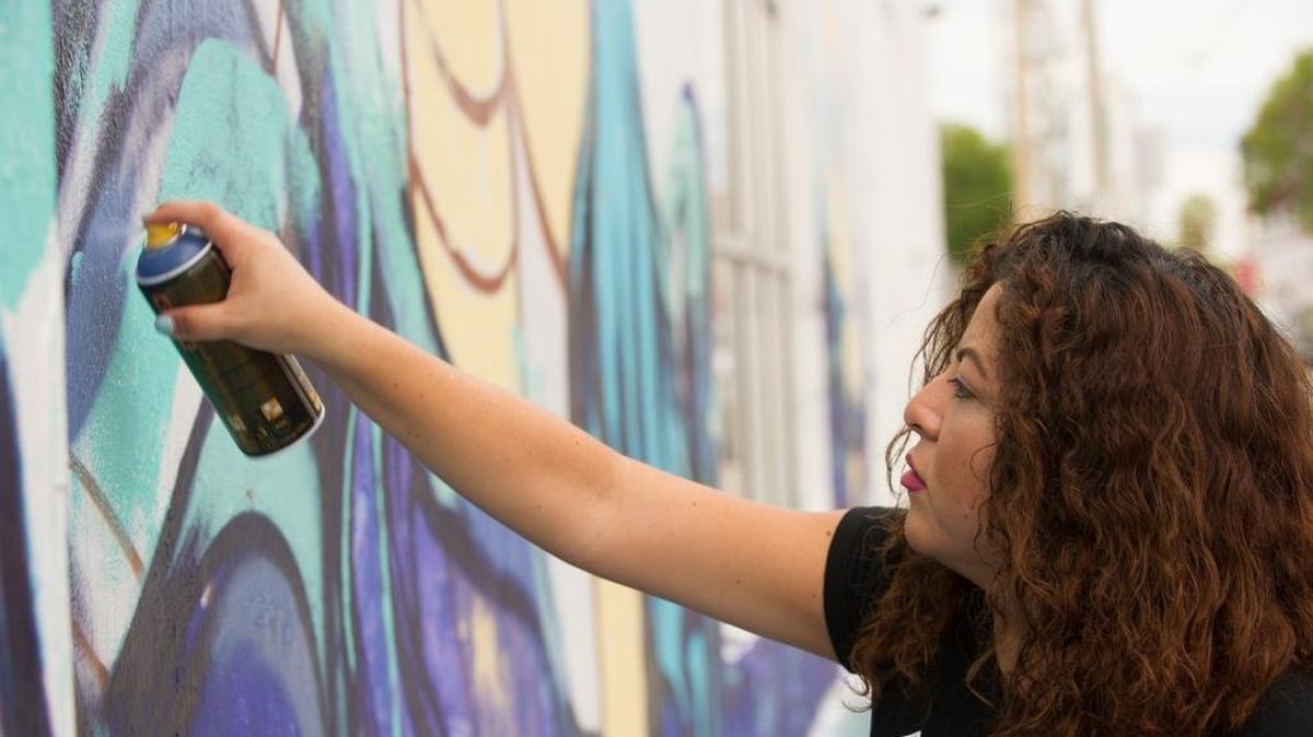 
Diana “Didi” Contreras, an artist from Coral Gables, works on a mural in Wynwood will be used as the poster for this year’s Miami Book Fair International poster.
