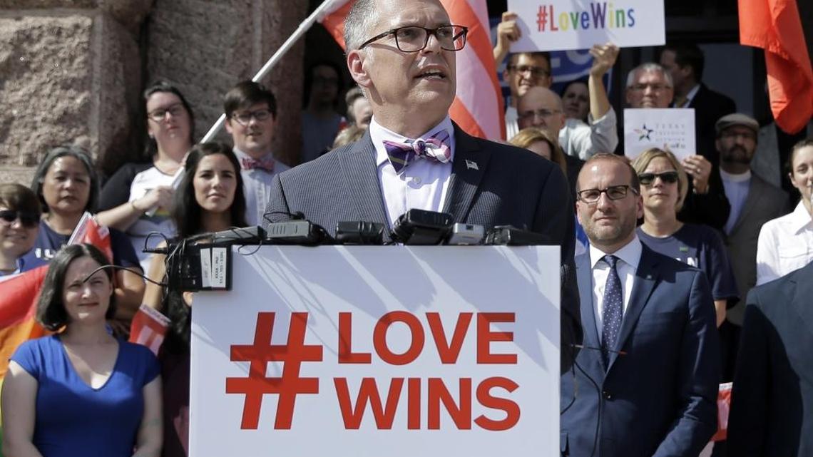 In this June 29, 2015 photo, Jim Obergefell, the named plaintiff in the Obergefell v. Hodges Supreme Court case that legalized same sex marriage nationwide, is backed by supporters of the courts ruling on same-sex marriage on the step of the Texas Capitol during a rally in Austin, Texas.