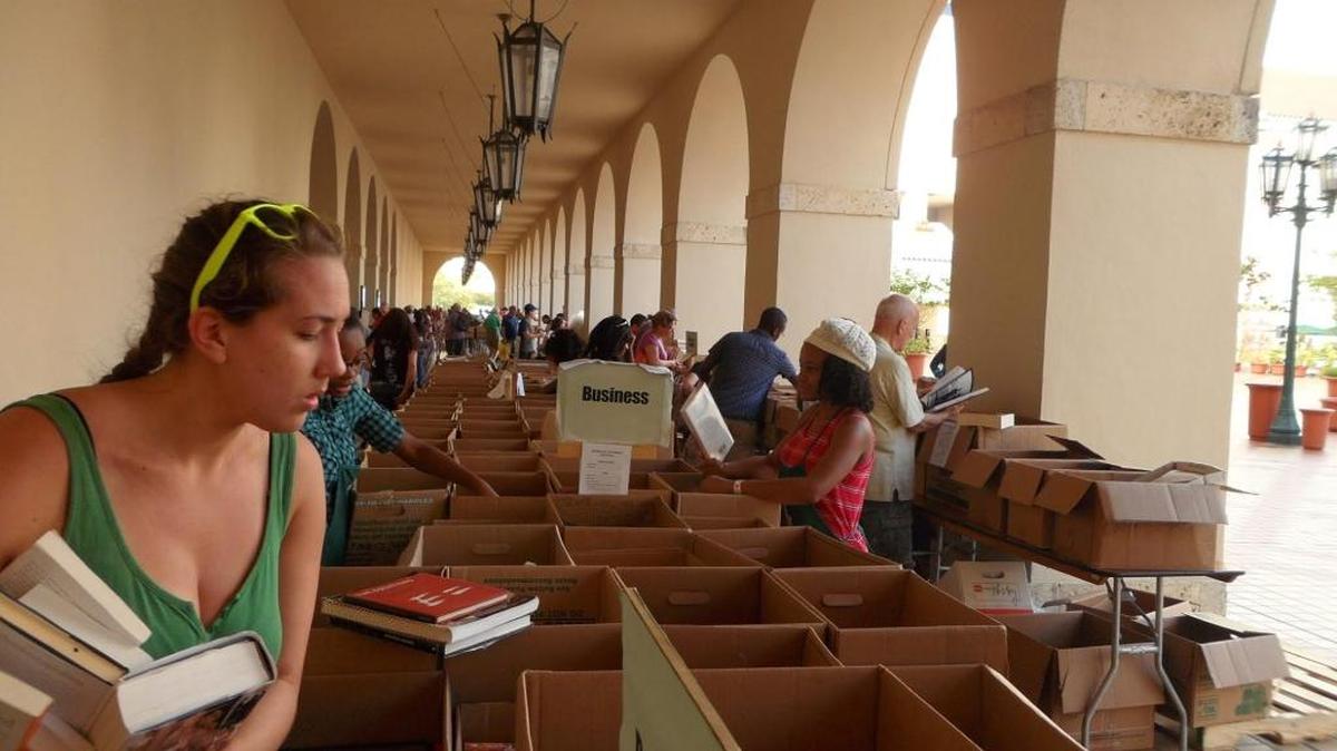 Bargain hunters scour the offerings at the 2013 Miami-Dade Public Library book sale.