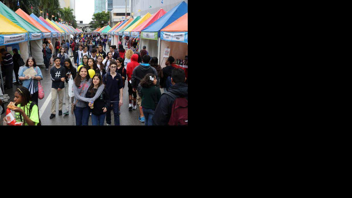 
Krystal Jerez,14, and Martina Maurici, 14, both students at MAST Academy FIU campus, make their way through the crowd of students at the Miami Book Fair International’s street fair on Friday, Nov. 21, 2014.

