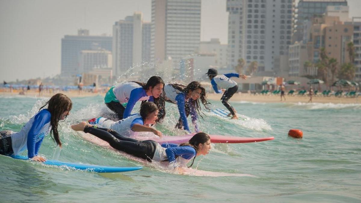 Young surfers get lessons in the Mediterranean at the Tel Aviv Surf School in a photo from ‘The Desert and the Cities Sing.’