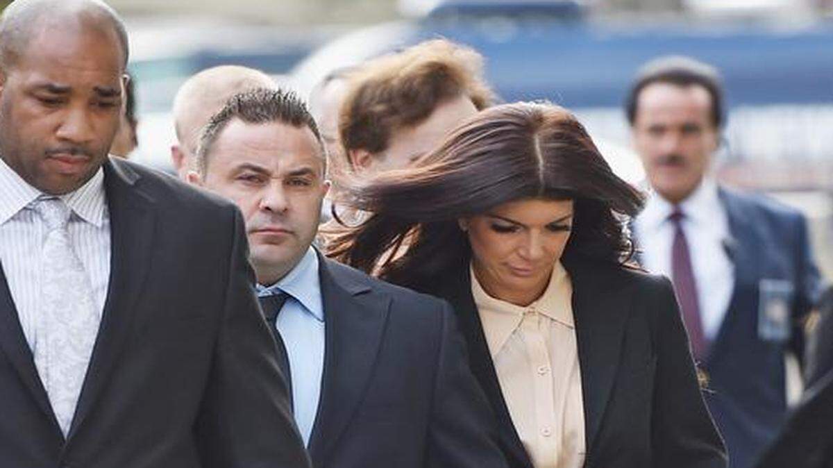 
Joe Giudice (seconnd from left) and wife Teresa Giudice arrive for sentencing at federal court in Newark on October 2, 2014 in Newark, New Jersey.
