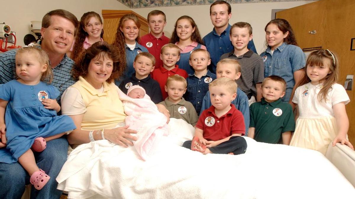 
FILE -- In this Aug. 2, 2007 file photo, Michelle Duggar, left, poses with her husband Jim Bob, second from left, and children, including their oldest son Josh, tallest standing, after the birth of her 17th child in Rogers, Ark. Calling himself "the biggest hypocrite ever," ex-reality star Josh Duggar has apologized for a "secret addiction" to pornography and for cheating on his wife he said in a statement posted Thursday, Aug. 20, 2015, on the family's website. The statement was apparently spurred by Duggar's name appearing among millions exposed in a data breach of customers of the Ashley Madison website, an online service that caters to men and women looking to cheat on their spouses. (AP Photo/Beth Hall, File).
