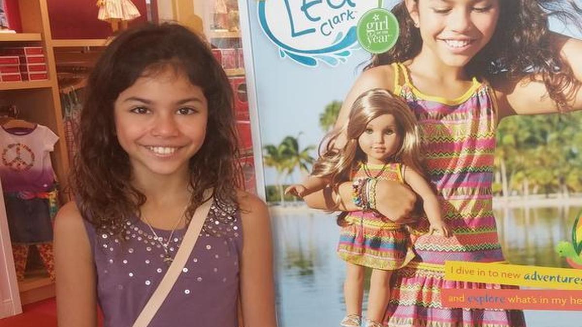 Alannah Keyser, a Miami model who appears on the cover of the American Girl catalog as well as the poster for Lea Clark poses at the AG store in the Falls Sunday Jan 3, two days after the announcement of the doll of the year