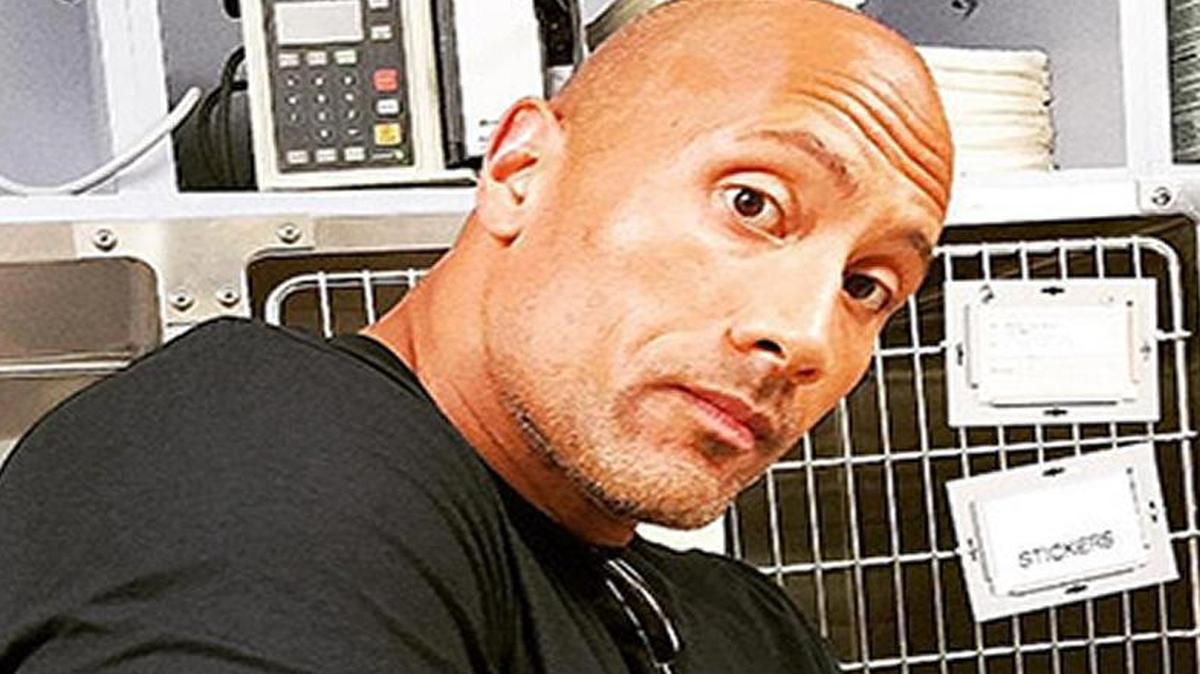 
The Rock (Dwayne Johnson) cradles his puppy Brutus who had to be put down on Sept 28 after eating mushrooms
