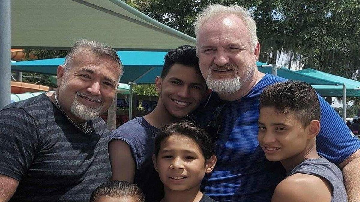 Art Smith, right, husband Jesus Salgueiro, left, with their family, Zumy, front left, Zuky, front right, Brando, center, Angel, right, and Diego, at Wild Adventures theme park in Valdosta, Ga. Oprah Winfrey’s former chef Smith and his husband have long been a fixture on the celebrity circuit, but now the gay rights advocates are on a mission to bring jobs and life back to Jasper, a small Florida city of about 1,600 and Smith’s birthplace. They’re also bringing their five children with them as they overhaul a historic mansion that will be a cooking and gardening school. (Moraima Salgueiro via AP)