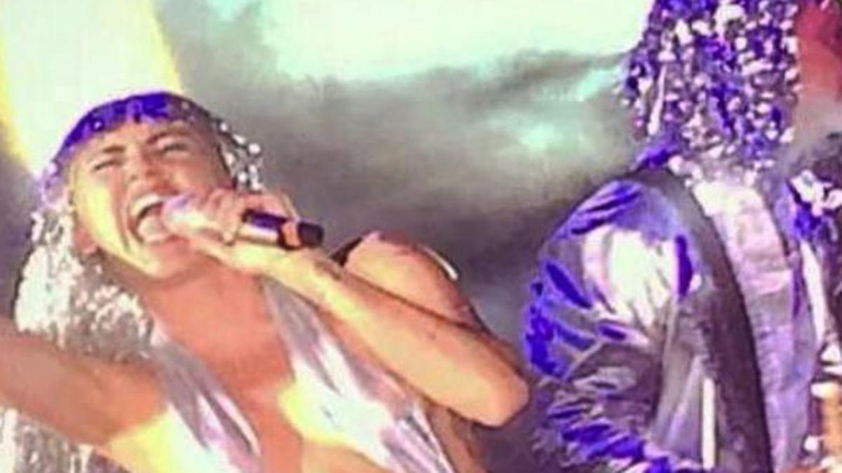 l, Miley Cyrus performs during a poolside show at the Raleigh Hotel, in Miami Beach, Fla. In a bizarre and emotionally transparent performance, Cyrus mocked her own music, opened up about her dark year, belted some Led Zeppelin and smoked pot onstage. (AP Photo/Lesley Abravanel)