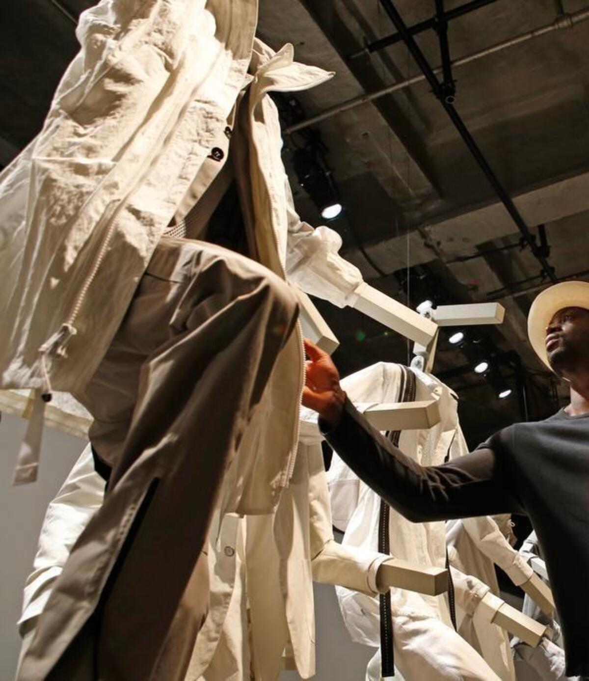 
Miami Heat guard Dwyane Wade looks at clothing displayed on mannequins during the Rag and Bone Spring/Summer 2016 presentation at Men's Fashion Week in New York, Tuesday, July 14, 2015. Wade and New York Giants wide receiver Victor Cruz teamed up to promote men's fashion along with other celebrities and big names in fashion. (AP Photo/Kathy Willens)
