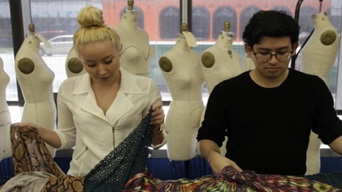 
cirque work: Miami International University of Art & Design fashion students Chelsea Vega and Sebastian Cubides check out fabric. Students competed in a Cirque du Soleil contest testing their creativity. 

