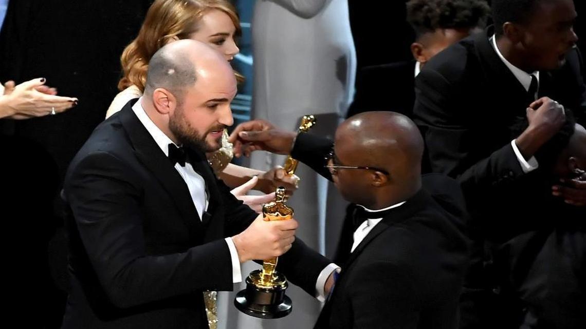 ''La La Land' producer Jordan Horowitz, left, hands over the Best Picture award to 'Moonlight' writer/director Barry Jenkins following a presentation error onstage during the 89th Annual Academy Awards at Hollywood & Highland Center on February 26, 2017 in Hollywood, California.