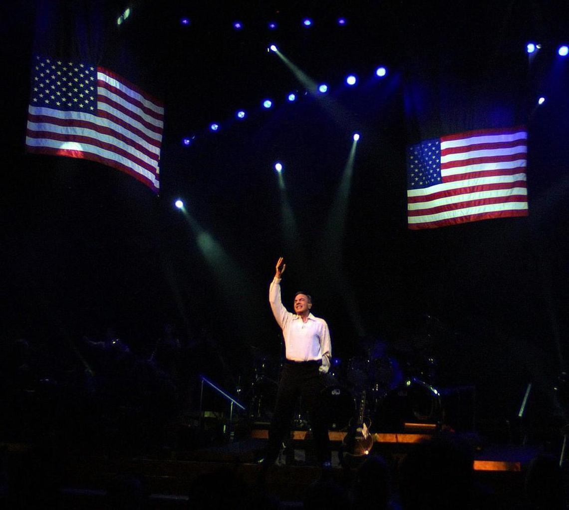 Against a backdrop of American flags, Neil Diamond performed “America” to a sold-out crowd on Feb. 12, 2002 at the American Airlines Arena in Miami.