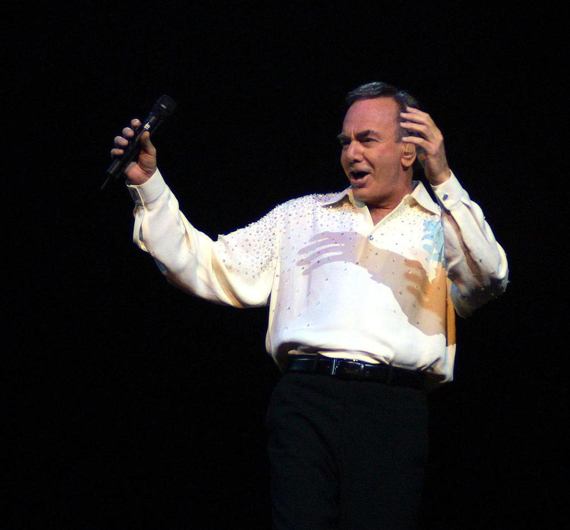 Neil Diamond raises his hands as he sings to a sold-out crowd on Feb. 12, 2002 at the American Airlines Arena in Miami.