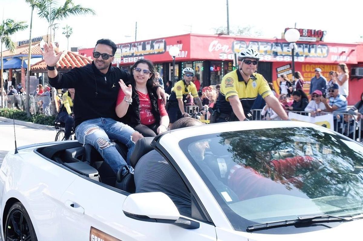 Luis Fonsi, the grand marshal of the Three Kings Parade, waves to people along the Little Havana parade route on Sunday, Jan. 14, 2018.