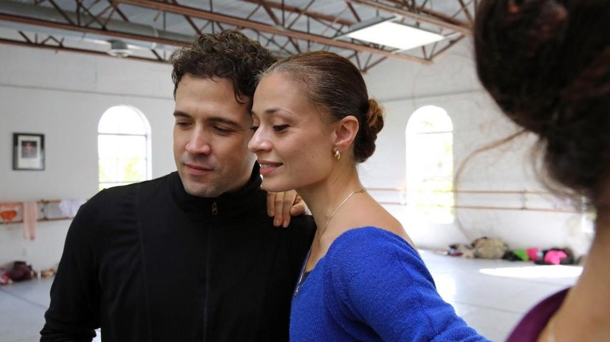 Former Miami City Ballet principal dancers Carlos Guerra and Jennifer Kronenberg watch rehearsal video of their new troupe, Dimensions Dance Theater, which debuts Sunday.