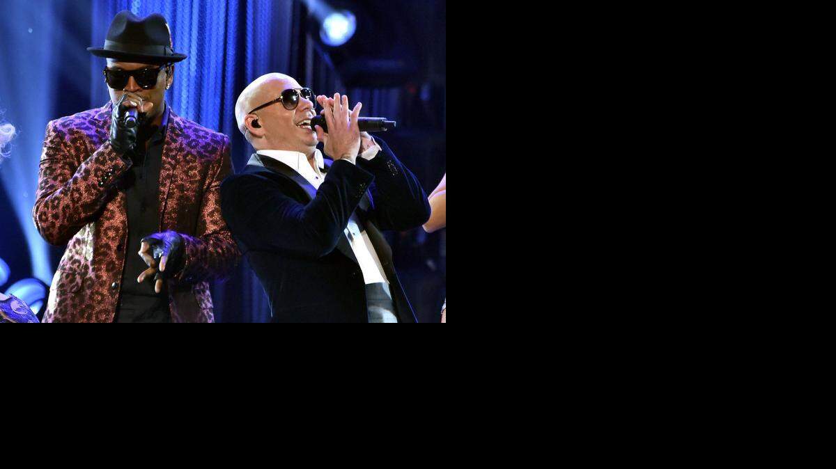 
 Recording artist Ne-Yo (L) and host Pitbull perform onstage at the 2014 American Music Awards at Nokia Theatre L .A . Live on November 23, 2014 in Los Angeles, California . (Photo by Kevin Winter/Getty Images)
