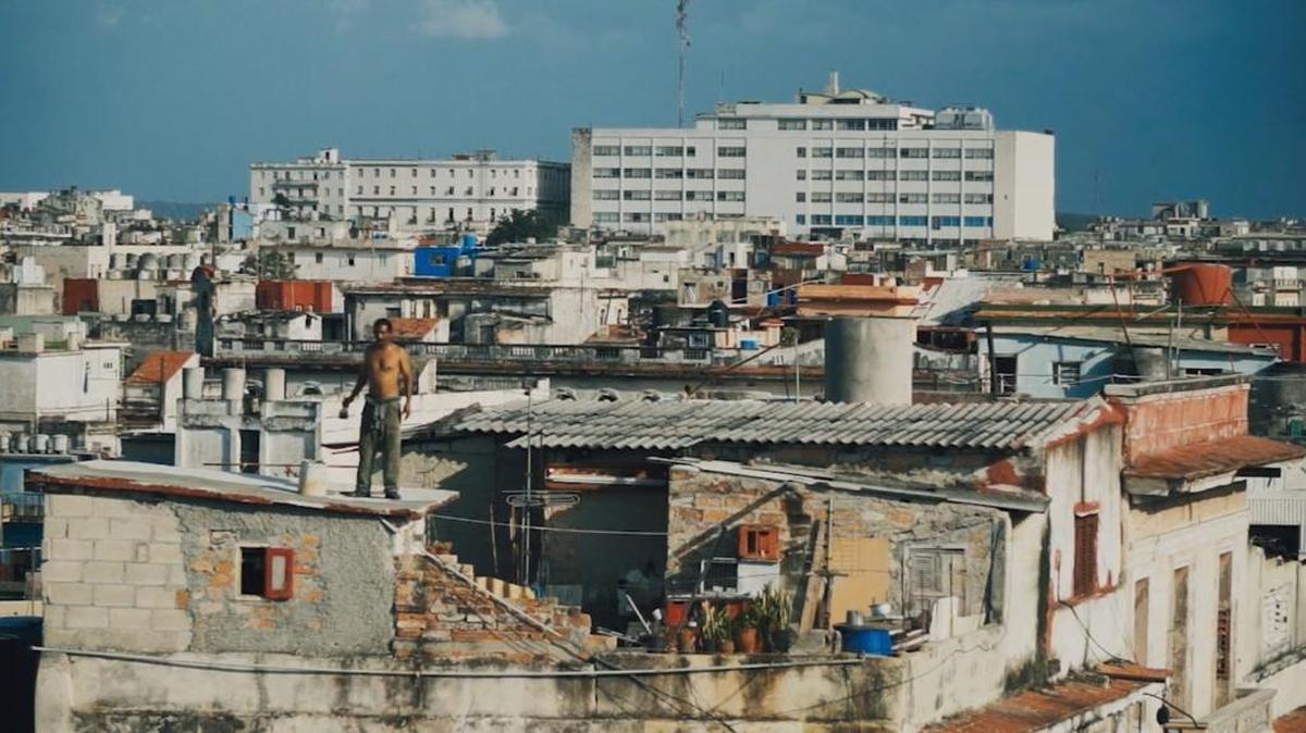 A man stands atop a rooftop in Havana in the documentary ‘Patria o Muerte: Cuba, Fatherland or Death.’