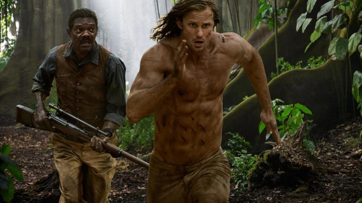 John Clayton (Alexander Skarsgard) and George Washington Williams (Samuel L. Jackson) run through the jungle in ‘The Legend of Tarzan.’