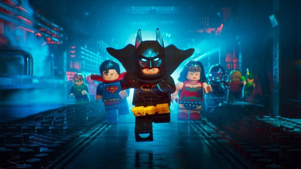 The Dark Knight (voiced by Will Arnett) gets a little help from his superfriends in a scene from ‘The LEGO Batman Movie.’