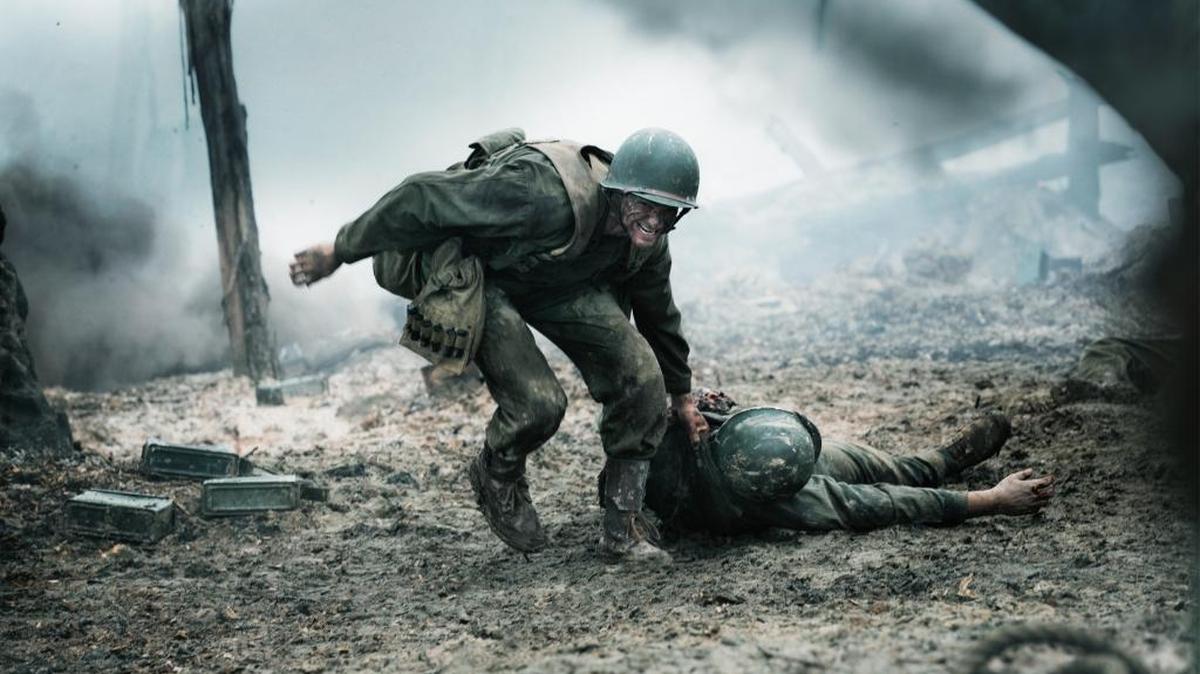 U.S. Army combat medic Desmond T. Doss (Andrew Garfield) helps a fellow soldier in ‘Hacksaw Ridge.’