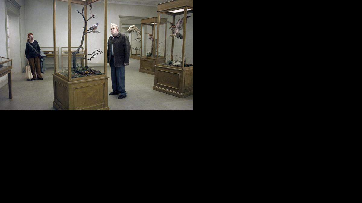 
A man studies a wildlife exhibit at a museum in ‘A Pigeon Sat on a Branch Reflecting on Existence.’
