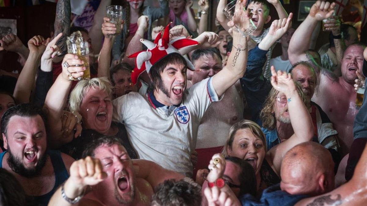 Nobby (Sacha Baron Cohen, center) and his band of merry soccer hooligans in a scene from ‘The Brothers Grimsby.’