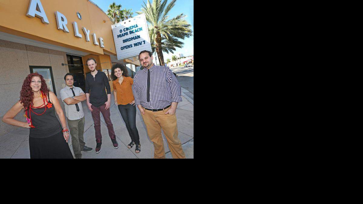 
Vivian Marthell and Kareem Tabsch, co-directors of O Cinema, in front of their new Beach theater with staff members.
