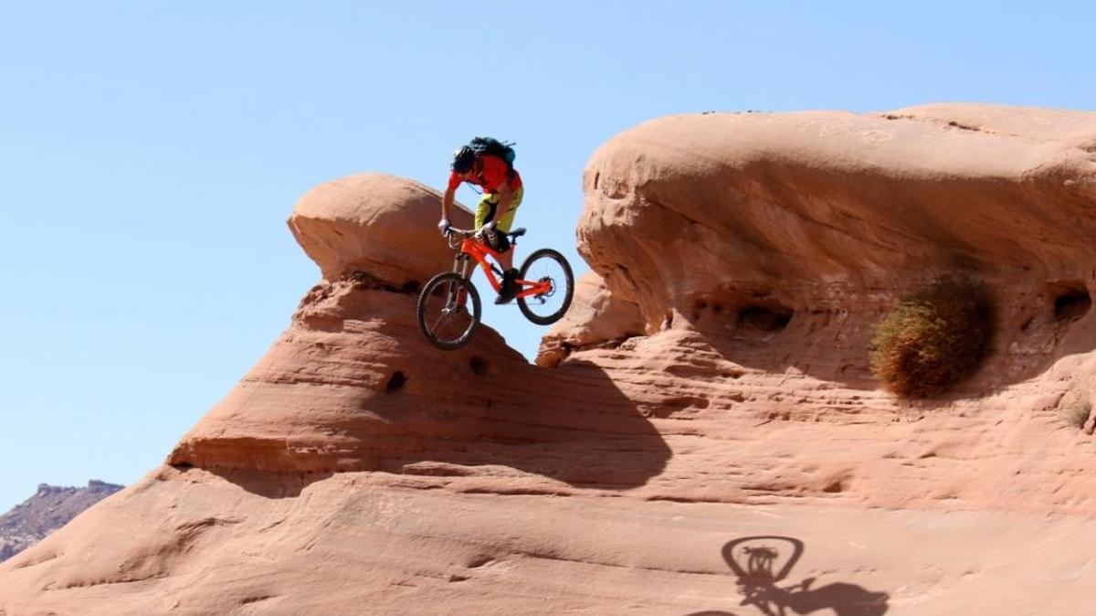 Mountain biker Eric Porter jumps over a mushroom boulder in Moab, Utah.