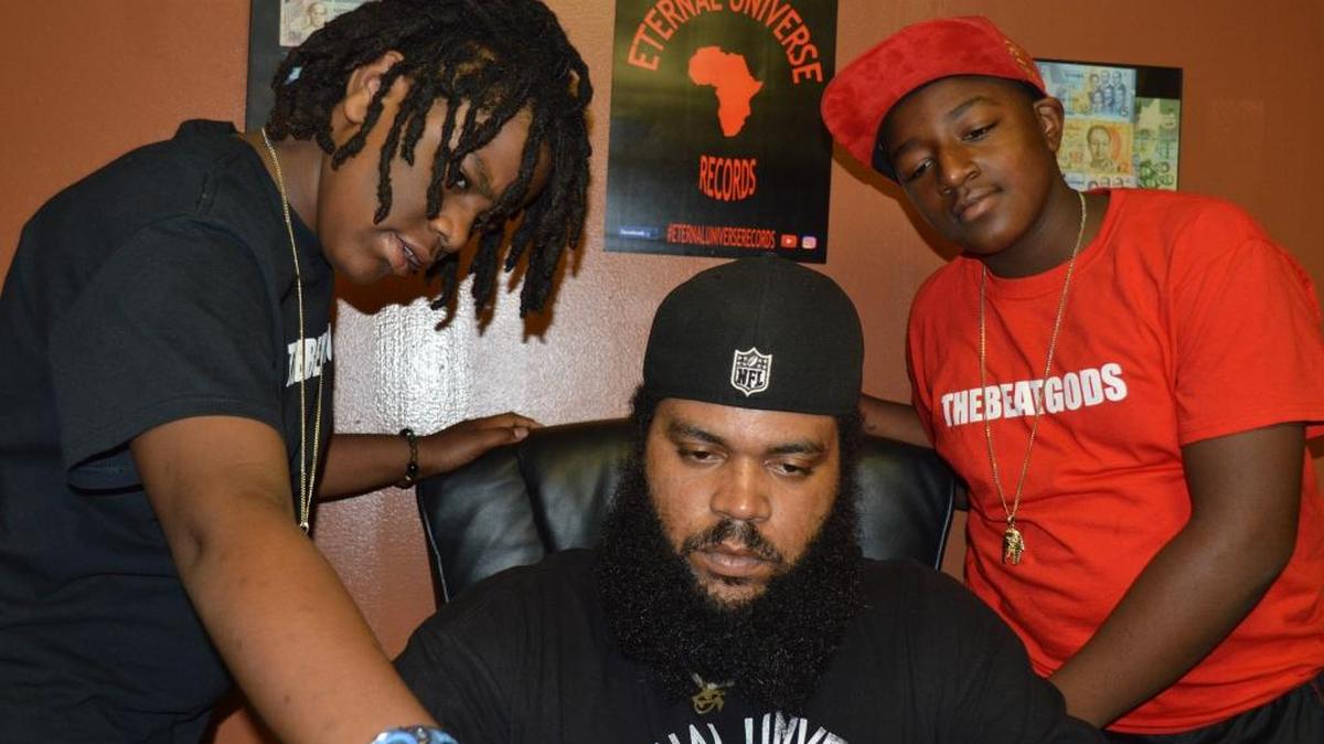 William “Will The God” Gomez, center, discusses an upcoming project with his sons, Cassius Gomez (Cash The God), left, and Antoine Jones (AJ The God).