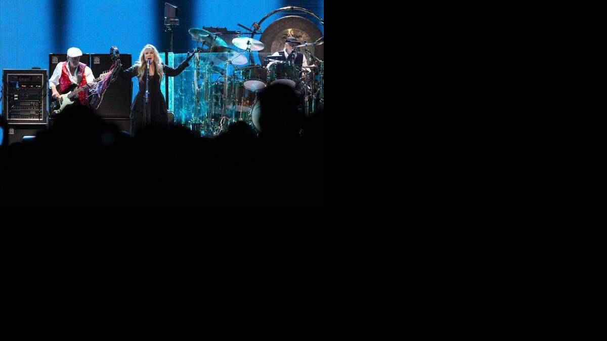 
ROCKING ‘RUMOURS’: Fleetwood Mac opens its reunion concert with ‘The Chain’ before a sold-out crowd at Sunrise's BB&T Center. Singer Stevie Nicks, center stage, bassist John McVie, (left) and drummer Mick Fleetwood, (right) were joined by guitarist Lindsey Buckingham and keyboardist Christine McVie, whose return after a 16-year absence allowed the band to reintroduce her hits like ‘You Make Loving Fun,’ ‘Over My Head’ and ‘Little Lies.’
