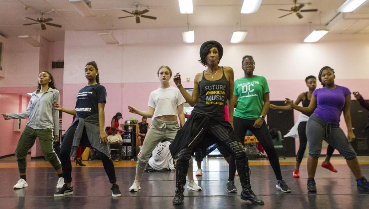 Nolwen "Mama Nola" Lalanne, center, leads a dance class of Entourage finalists during a rehearsal at the African Heritage Cultural Arts Center in Liberty City.