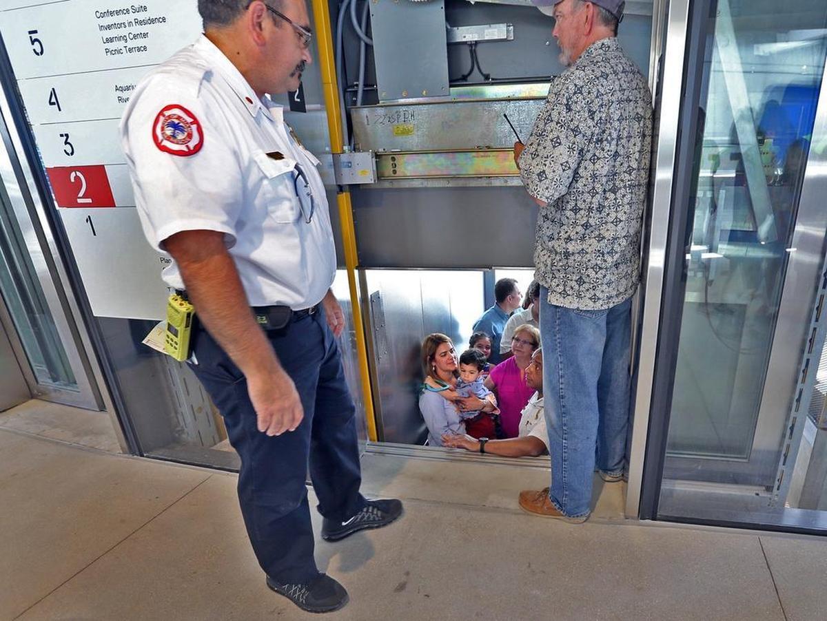 City of Miami Fire Rescue workers assist in getting an elevator back in service after it got stuck during the long-awaited opening of the Phillip and Patricia Frost Museum of Science on Sunday, May 7, 2017.