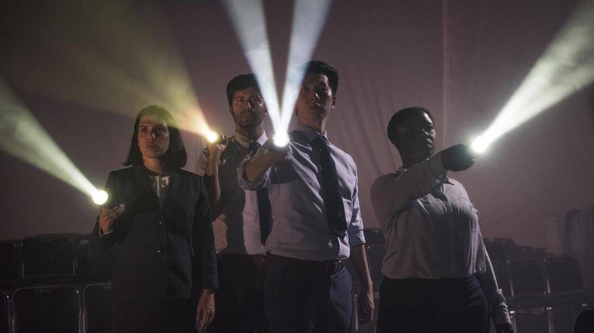 Actors simulate the effect of sunlight moving around the cabin of a DC-10 in the House Theatre of Chicago’s ‘United Flight 232.’