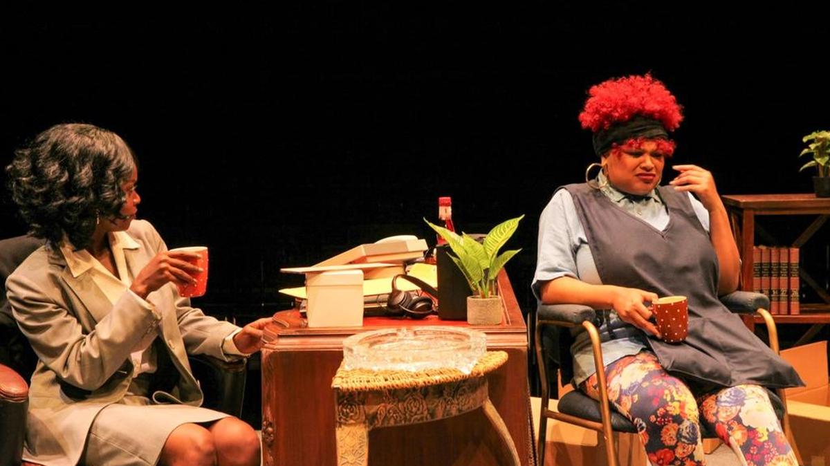 Tuesline Jean-Baptiste’s Olivia, left, and Chasity Hart’s Cassie sit out an unexpected snowfall with the help of liquer in a coffee cup in M Ensemble’s ‘Sisters.’