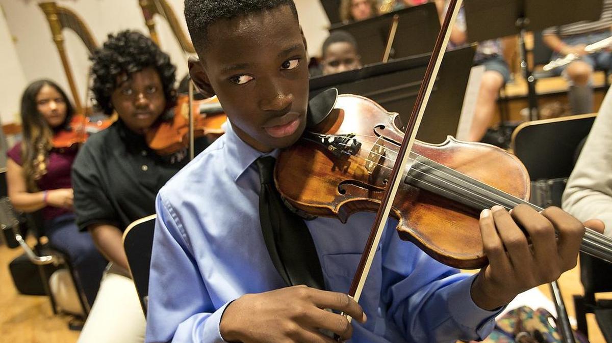 William Benoit, 14, plays his violin as the South Florida Youth Symphony practices at Miami Dade College North Campus on Sunday, Oct. 2, 2016.