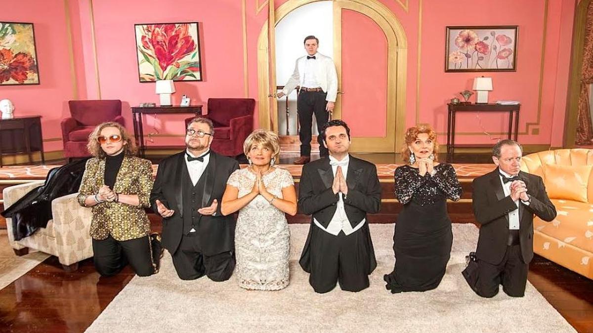 As Joe Ferrarelli looks on, Wesley Slade, Christopher Chisholm, Amy McKenna, Antonio Amadeo, Lourelene Snedeker and Michael McKeever say a little prayer in GableStage’s ‘It’s Only a Play.’