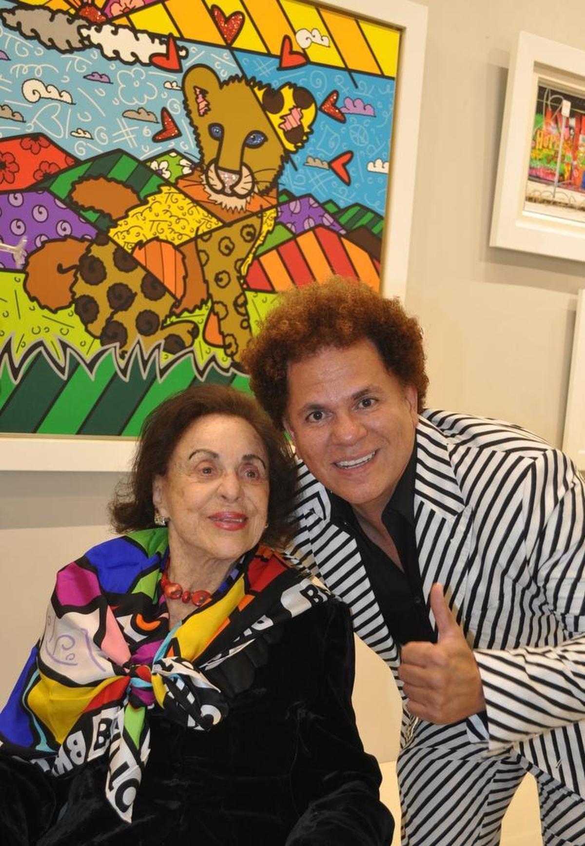Legendary Miami Beach impresaria Judy Drucker and artist Romero Britto on Dec. 20, 2016, at Britto Central gallery on Lincoln Road. Britto painted a pop portrait of Drucker in tribute.