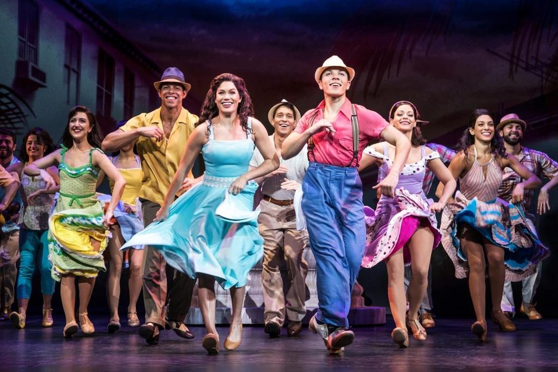 Christie Prades as Gloria Estefan dances alongside Adriel Flete with the “On Your Feet!” company at the Arsht Center.