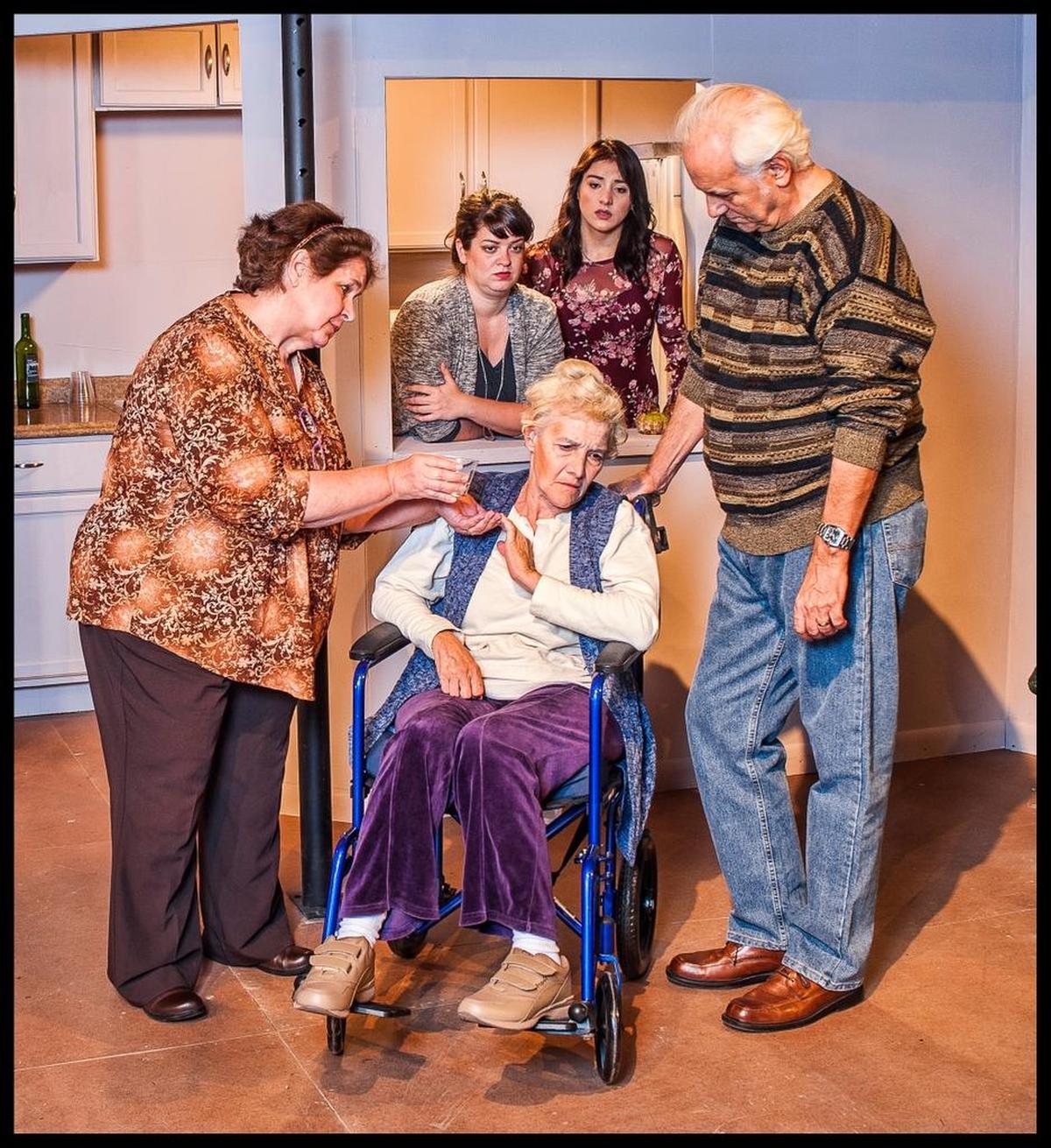 Elizabeth Dimon, Meredith Bartmon, Diana Garle and Michael Gioia try to get Carol Caselle as Moma to eat something in GableStage’s ‘The Humans.’