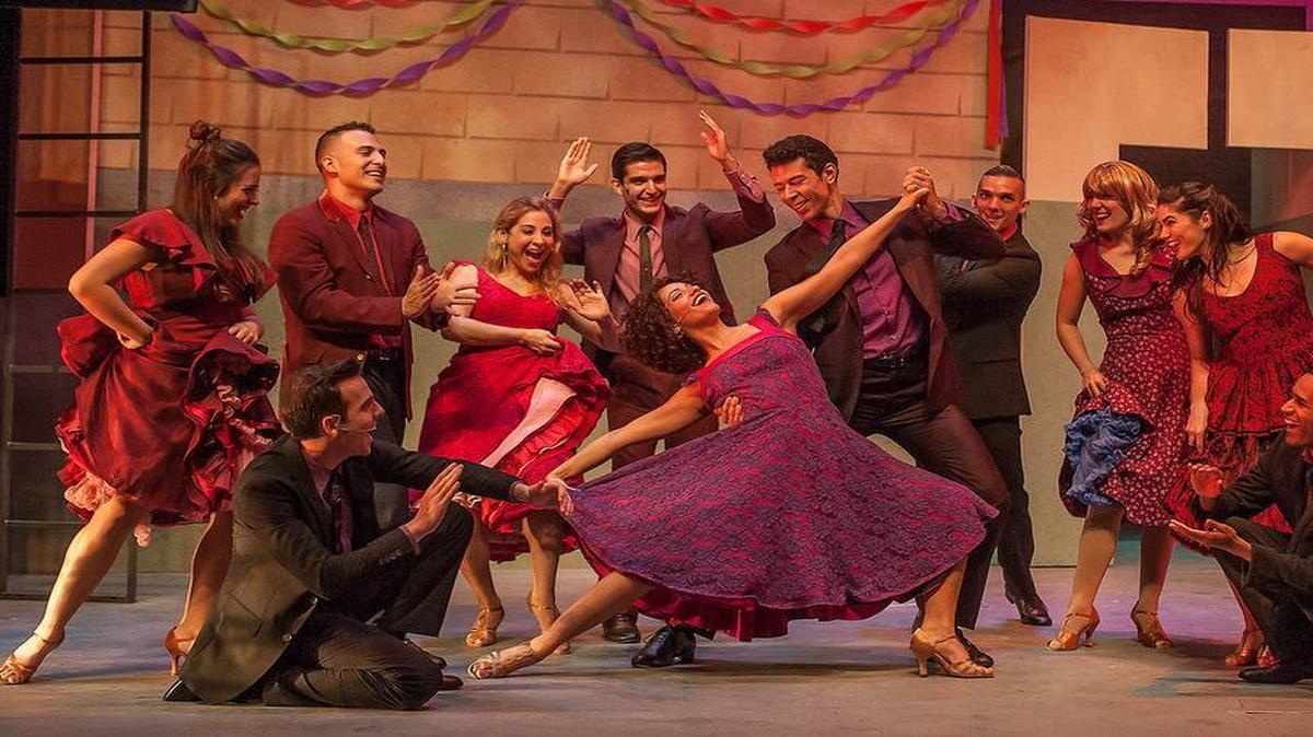 Isabelle McCalla (center) and Bernardo (Marco Antonio Santiago) lead the Sharks in a number in the vibrant ‘West Side Story’ at Actors’ Playhouse.