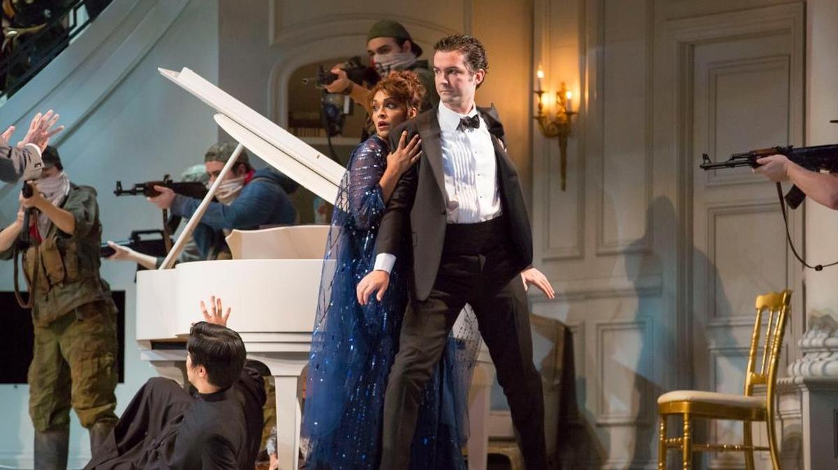 Danielle de Niese and John Irvin react as terrorists storm a mansion in Lyric Opera’s ‘Bel Canto.’