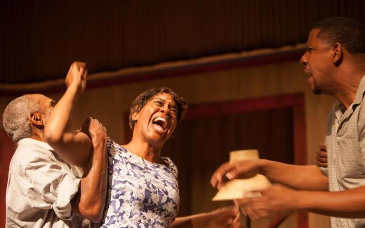 Uncle Doaker (Lowell Williams) tries to hold back Berniece (Makeba Pace) as she attacks Boy Willie (Ethan Henry) in M Ensemble’s ‘The Piano Lesson.’