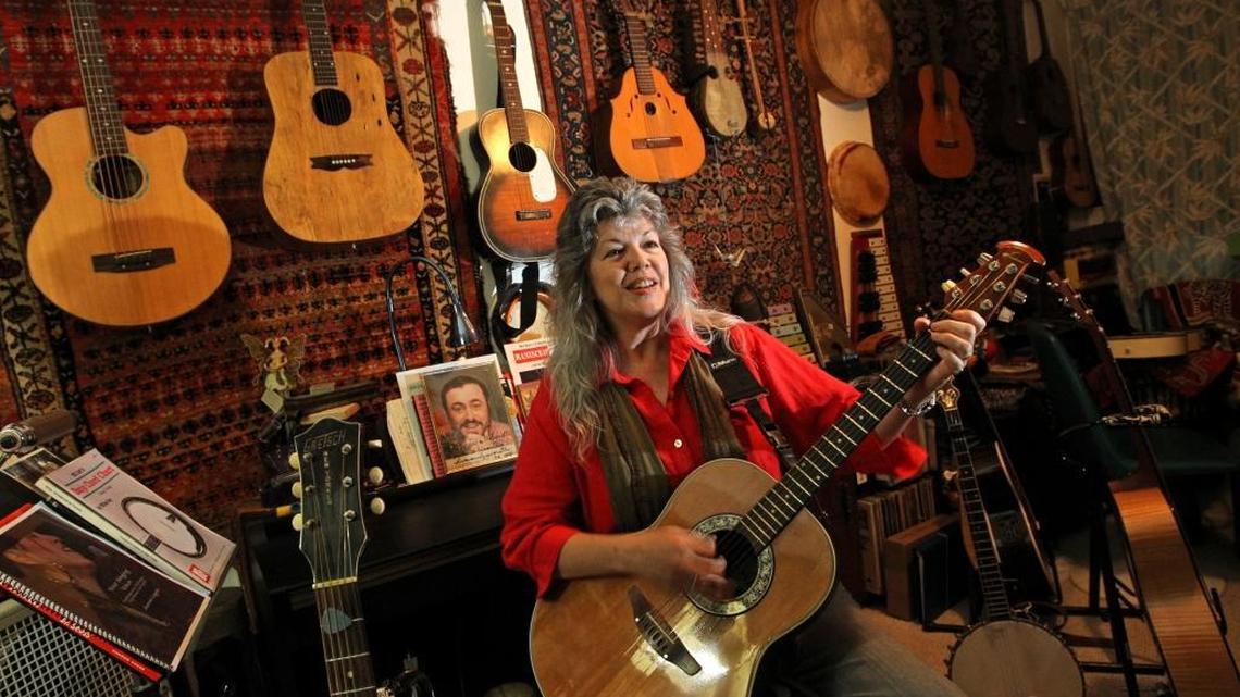 
Amy Carol Webb is surrounded by guitars at her home in Miami Springs. 
