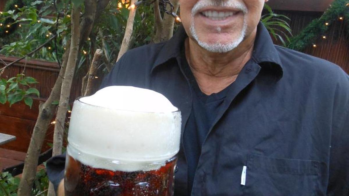 Owner-Chef Alex Richter hefts a giant mug of Pauline Oktoberfest beer in the beer garden at Schnitzel Haus on 79th Street.